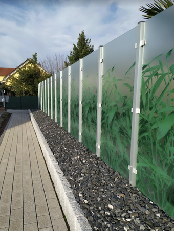 Zaun aus Glaselementen mit Grasmuster